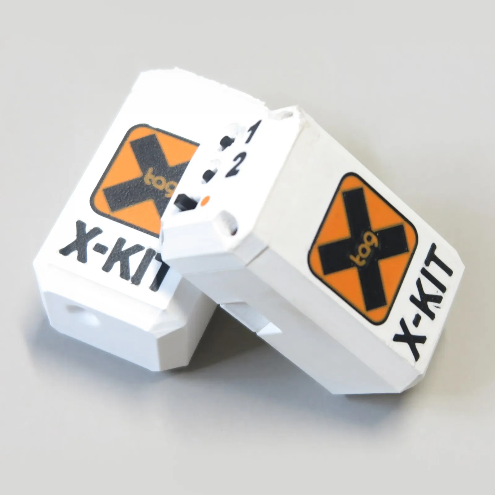 Dispositivo X-Kit X-Tag con emblema arancione — foto 1/3