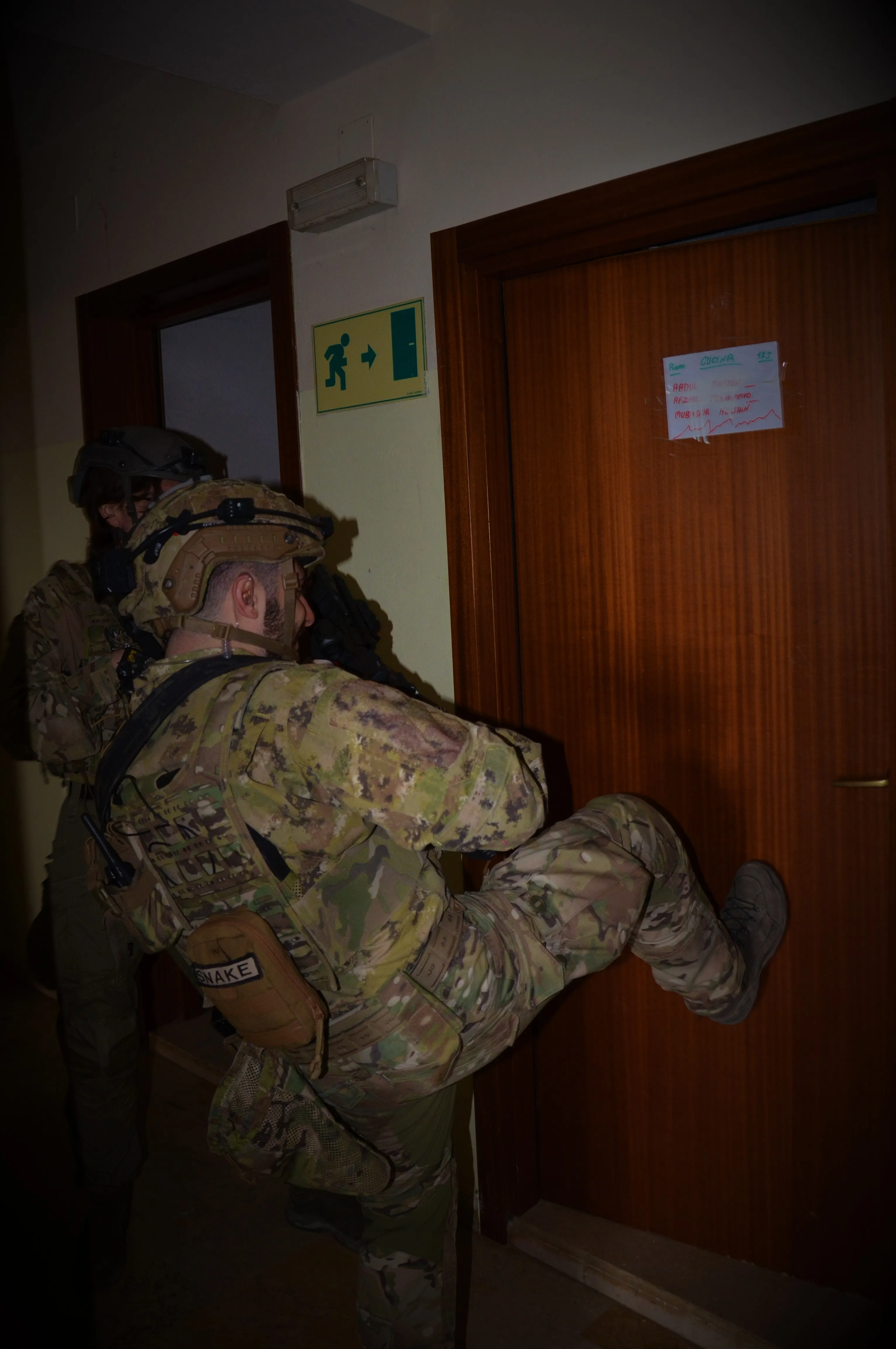 An X-Tag team breaching a door during a close-quarters battle scenario